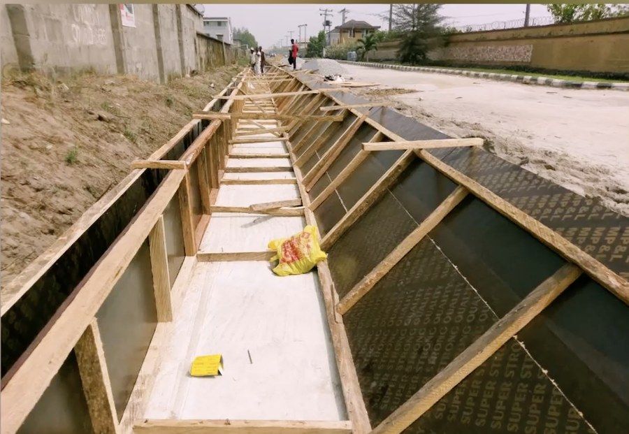 Drainage channel formwork set out along the road edge during construction