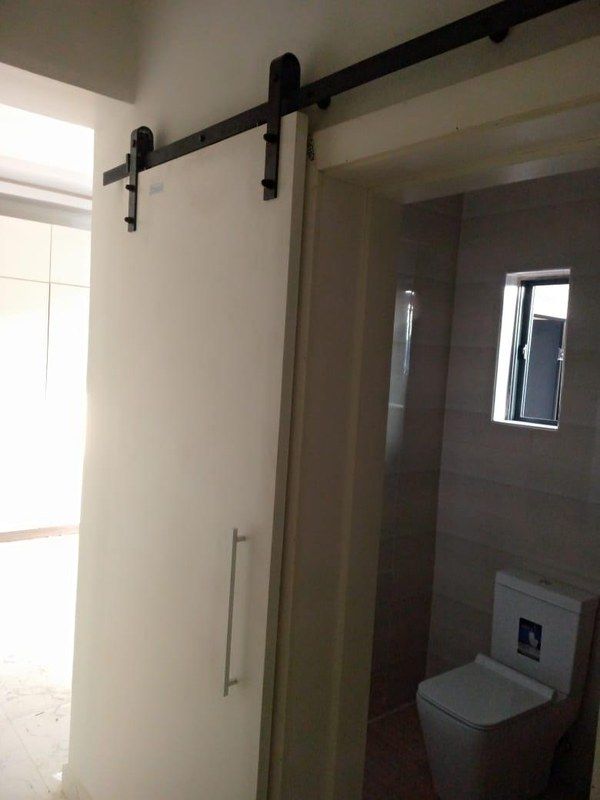 Bathroom with a sliding barn door and wall-hung WC