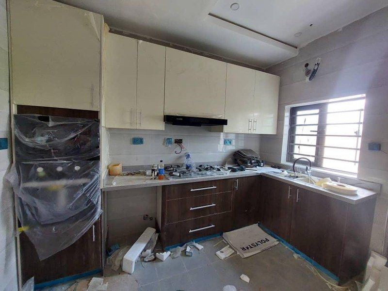 Fitted kitchen with cream wall units and dark base units