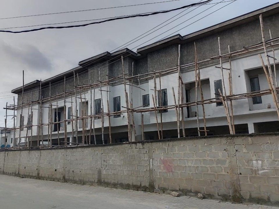 Orchid Road terraces during external works, with timber scaffolding against the façade